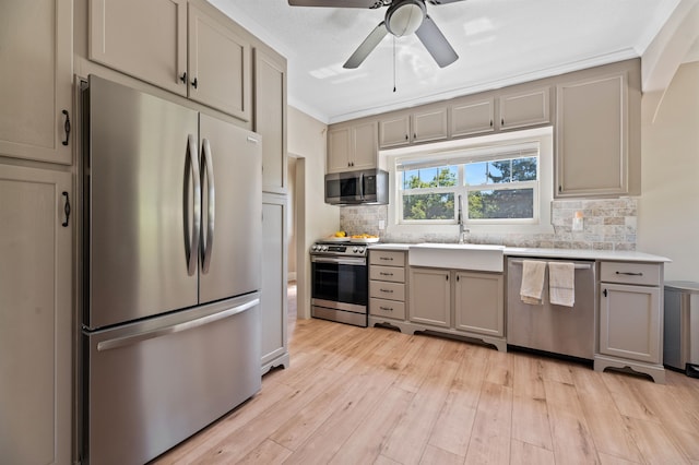 kitchen featuring light hardwood / wood-style flooring, stainless steel appliances, sink, gray cabinets, and ceiling fan