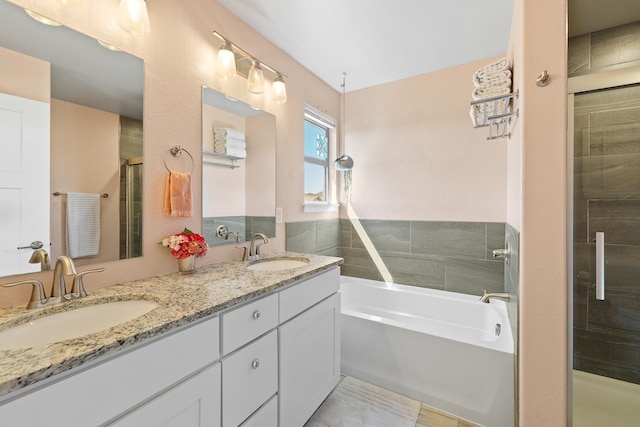 bathroom with vanity and independent shower and bath