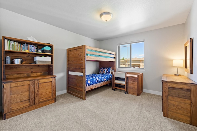 bedroom featuring light carpet