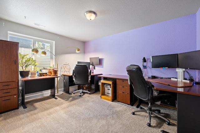 office area featuring a textured ceiling and light colored carpet