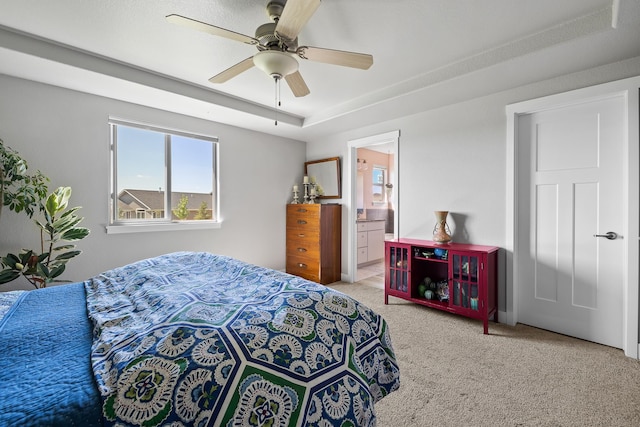 carpeted bedroom with ceiling fan and connected bathroom