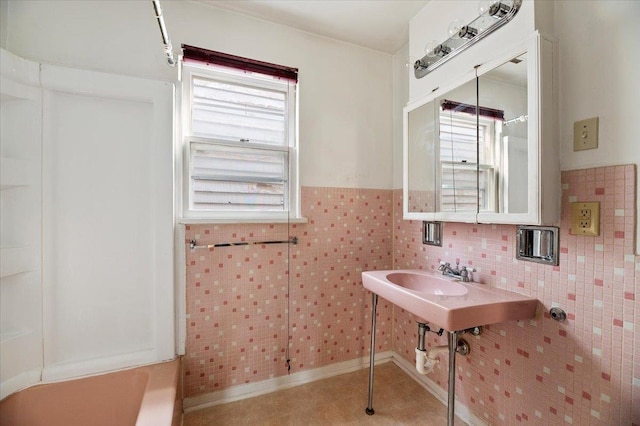 bathroom with tile walls and tile patterned floors