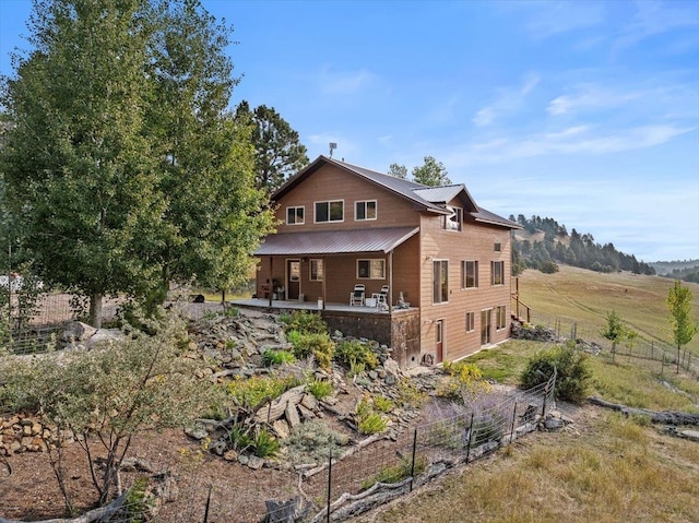 rear view of property featuring a rural view and a patio