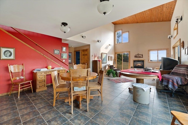 dining space with wooden ceiling and high vaulted ceiling