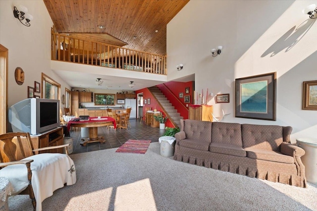 living room featuring wood ceiling, high vaulted ceiling, and dark carpet