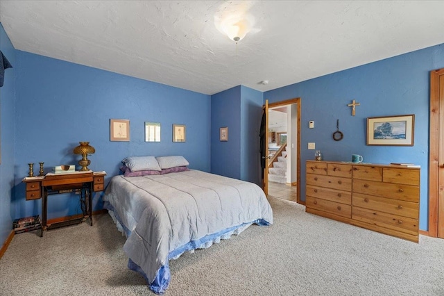 bedroom featuring a textured ceiling and carpet