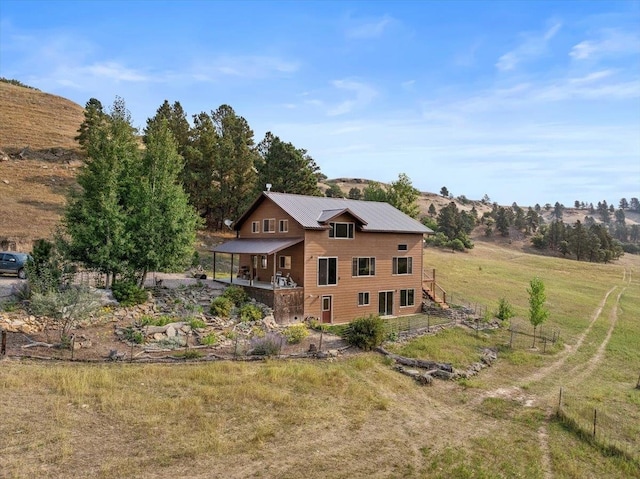 back of house with a rural view