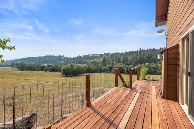 wooden terrace featuring a lawn