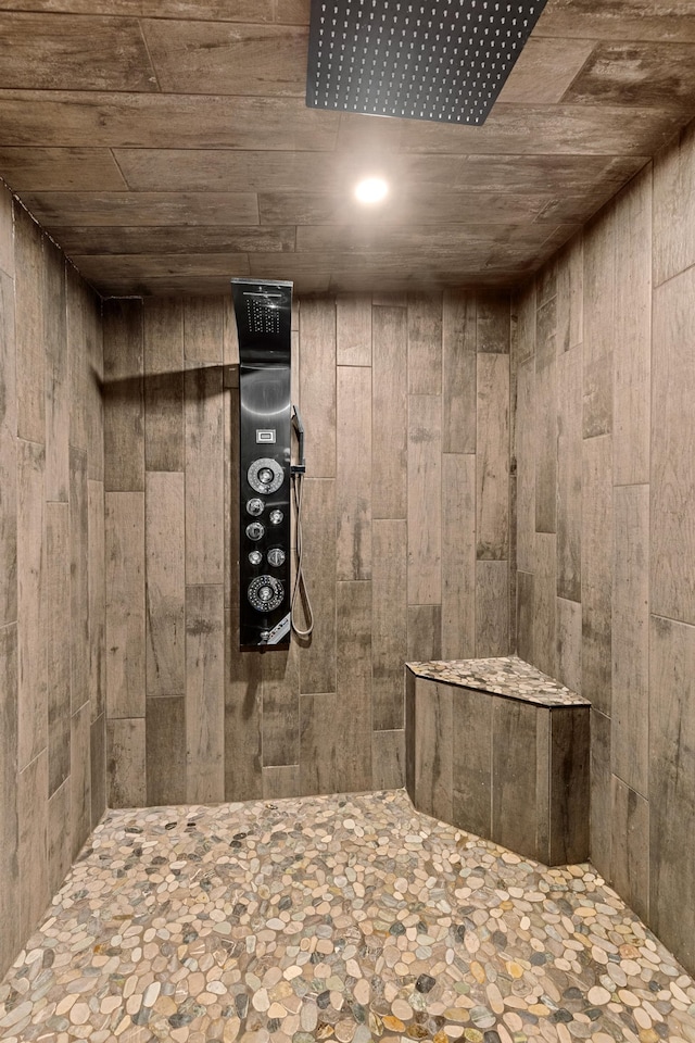 bathroom featuring wooden ceiling, walk in shower, and wood walls