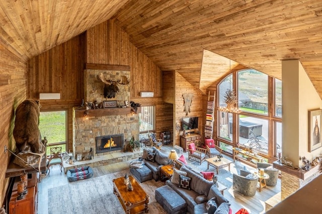 living room with hardwood / wood-style flooring, a fireplace, high vaulted ceiling, and a healthy amount of sunlight