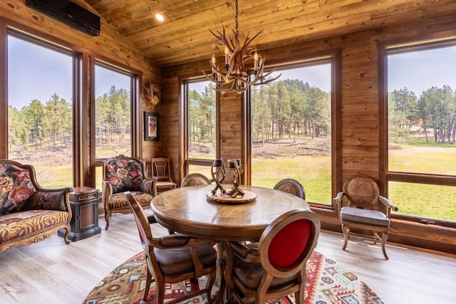 dining space with vaulted ceiling, wood ceiling, plenty of natural light, and light hardwood / wood-style floors