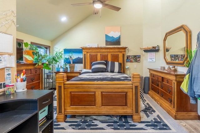 bedroom with ceiling fan, light hardwood / wood-style flooring, and vaulted ceiling