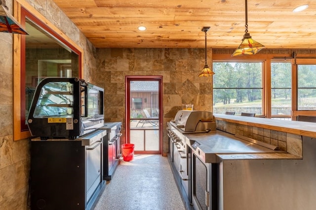 kitchen featuring hanging light fixtures and wooden ceiling