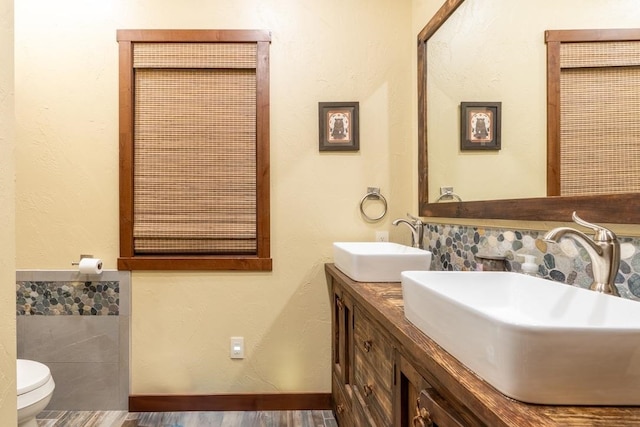 bathroom with vanity, toilet, and hardwood / wood-style flooring