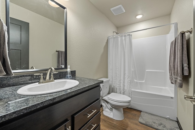 full bathroom with shower / bath combination with curtain, vanity, hardwood / wood-style floors, and toilet