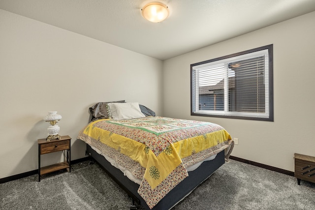 bedroom with dark colored carpet