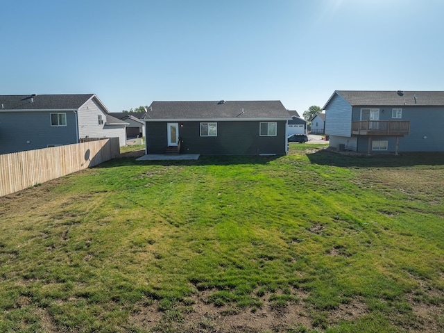 back of property featuring a lawn and a patio