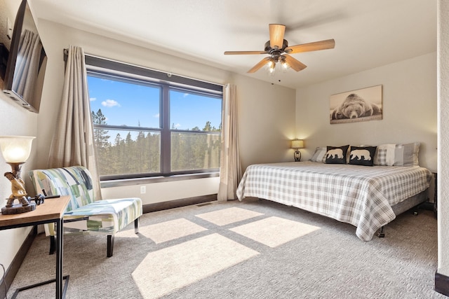 carpeted bedroom with baseboards and ceiling fan