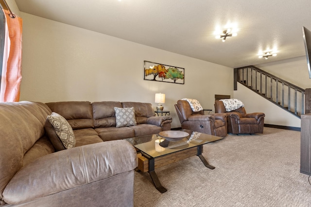 carpeted living area featuring stairs and baseboards