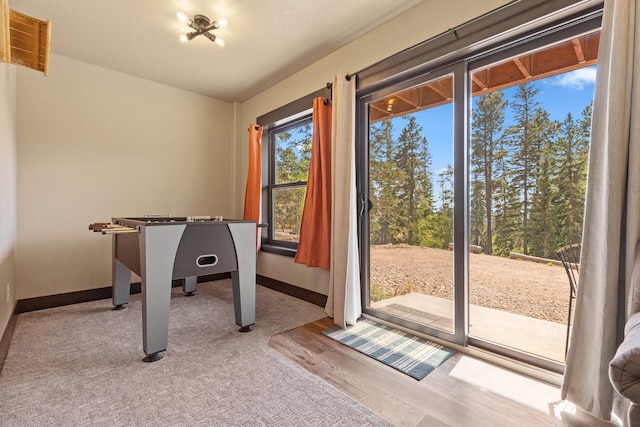 recreation room with baseboards