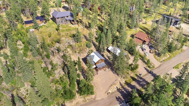 birds eye view of property featuring a view of trees