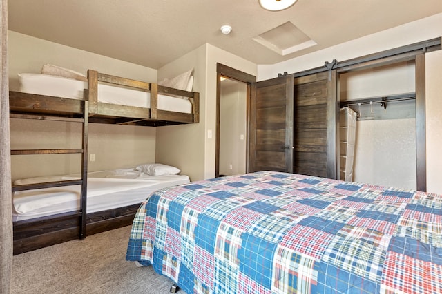 bedroom featuring carpet floors, a closet, and a barn door