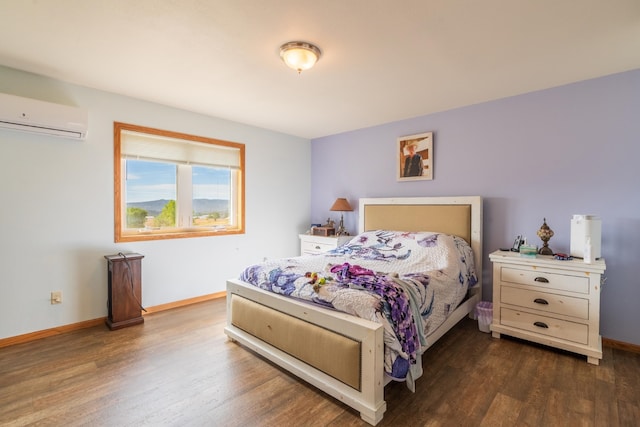 bedroom with a wall unit AC and dark wood-type flooring