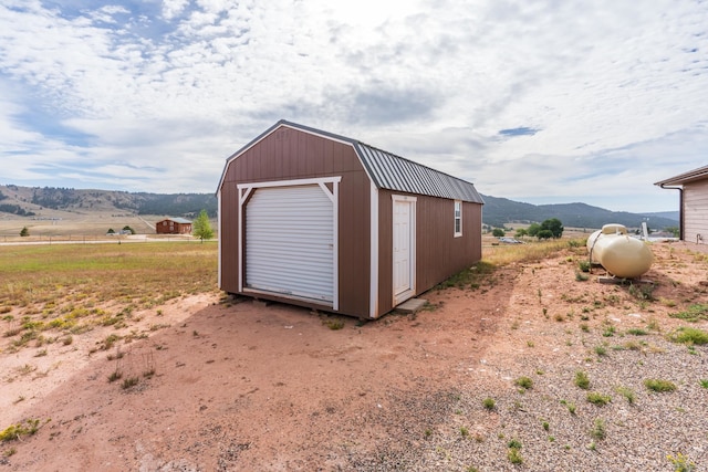 garage featuring a rural view and a mountain view