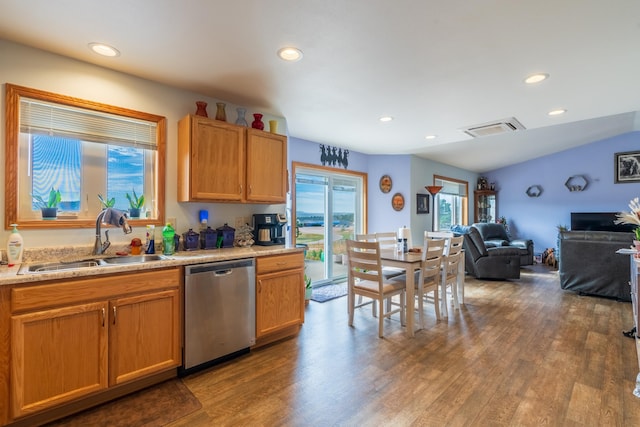 kitchen featuring dark wood-type flooring, sink, lofted ceiling, and stainless steel dishwasher