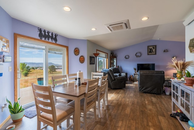 dining room with lofted ceiling, dark wood-type flooring, and a healthy amount of sunlight