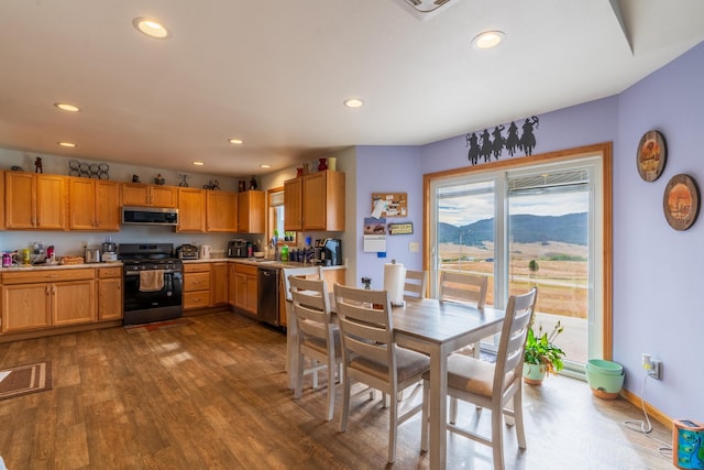 dining space with dark hardwood / wood-style floors and sink