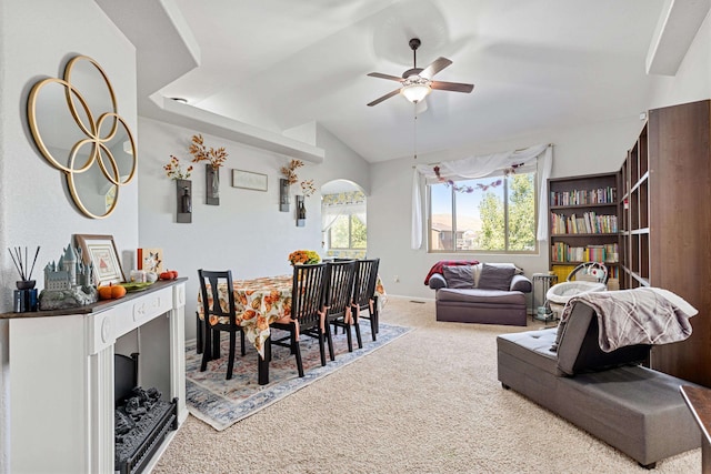 living room with vaulted ceiling, ceiling fan, and carpet floors