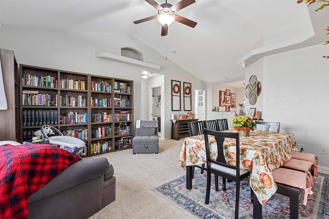 carpeted dining room featuring vaulted ceiling and ceiling fan