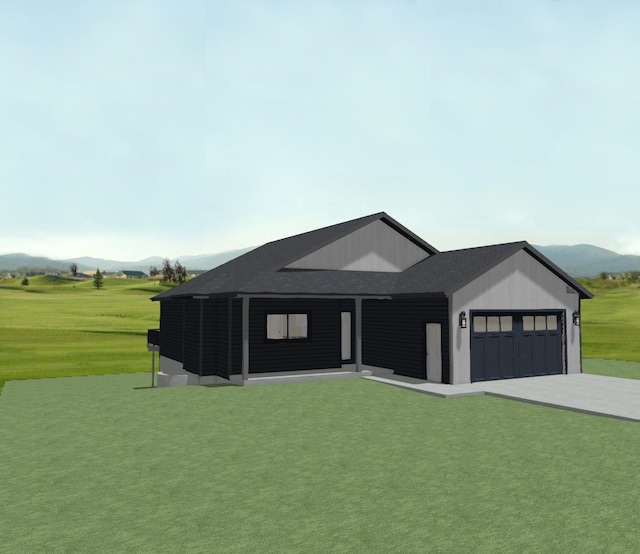 view of front of house with a mountain view, a garage, and a front lawn