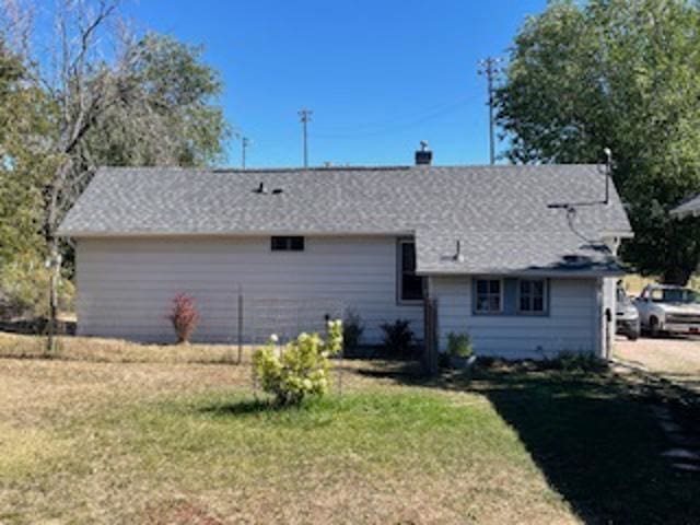 rear view of house with a yard