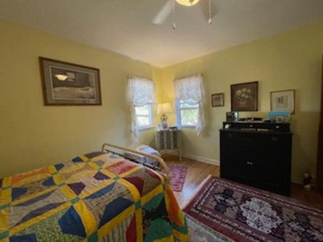 bedroom featuring ceiling fan and hardwood / wood-style flooring