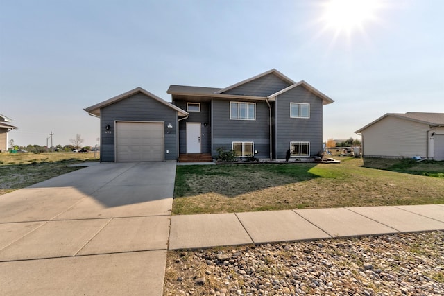 view of front of property with a front yard and a garage