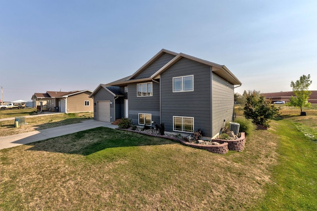 rear view of property with a garage and a lawn