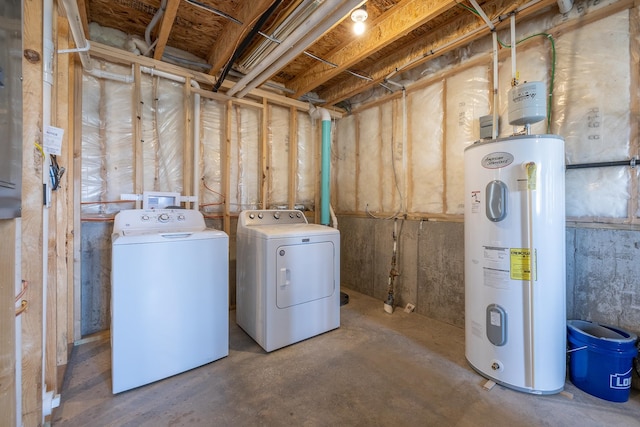 basement featuring electric water heater and separate washer and dryer