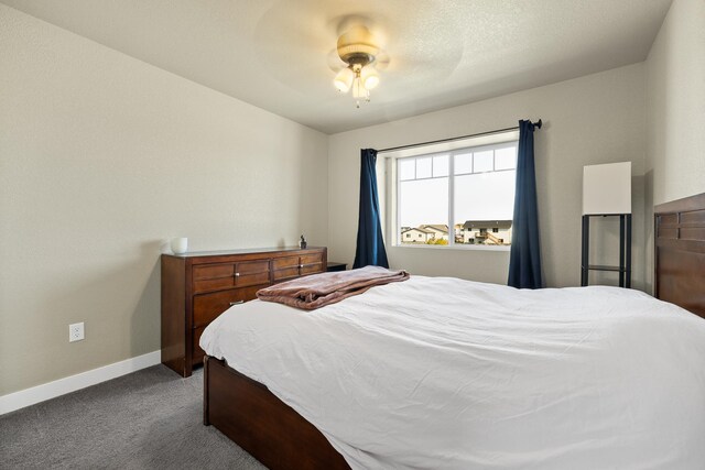 bedroom with ceiling fan and light carpet