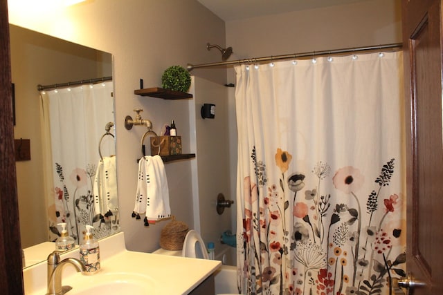 bathroom with shower / bath combo with shower curtain and vanity