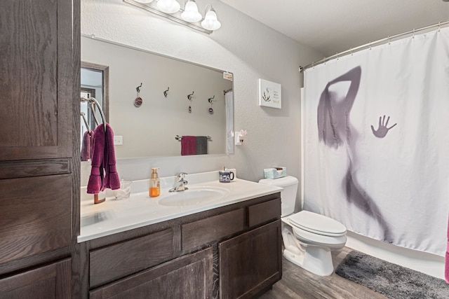 bathroom featuring hardwood / wood-style floors, a shower with curtain, vanity, and toilet