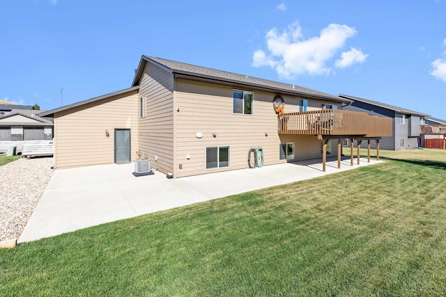 rear view of house with a patio, a lawn, and a deck