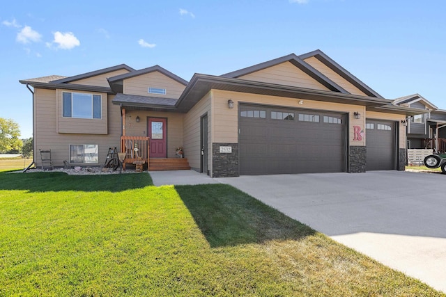 view of front of property with a garage and a front lawn