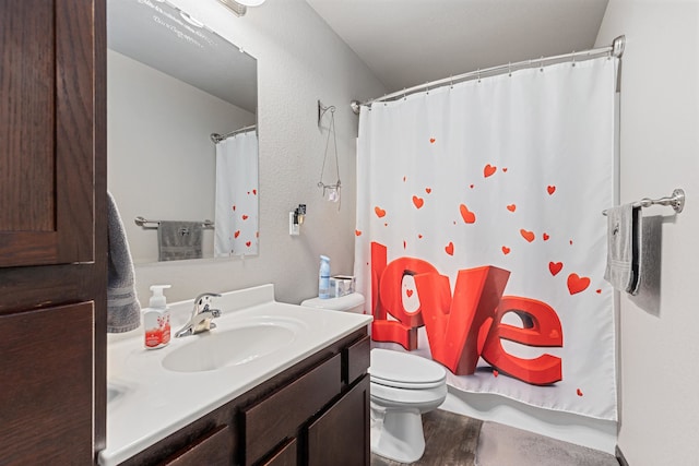 bathroom featuring vanity, toilet, and a shower with shower curtain