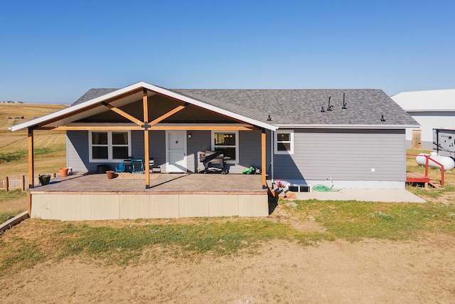 back of property with a yard and a patio