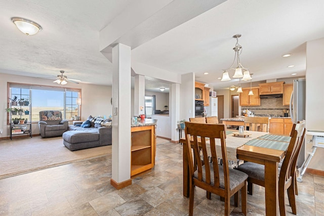 dining room featuring ceiling fan and a textured ceiling