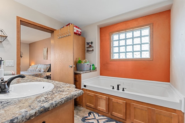 bathroom with vanity and a tub