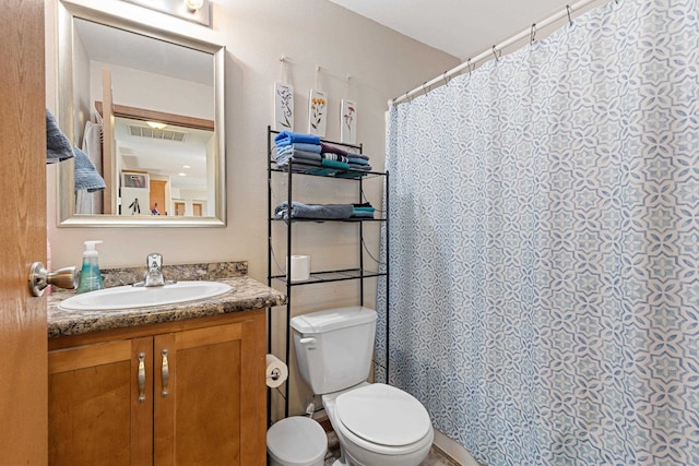 bathroom with a shower with curtain, vanity, and toilet