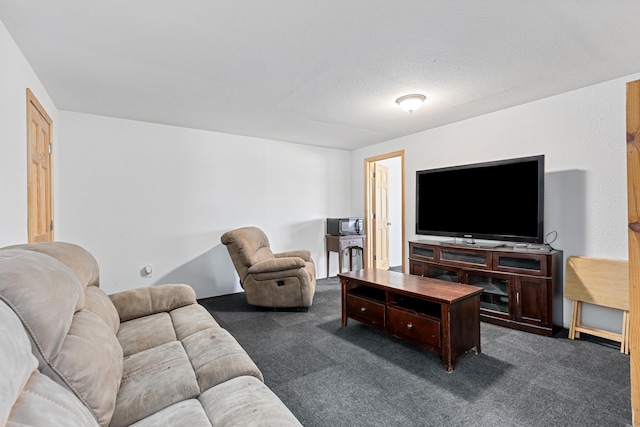 living room featuring dark carpet and a textured ceiling